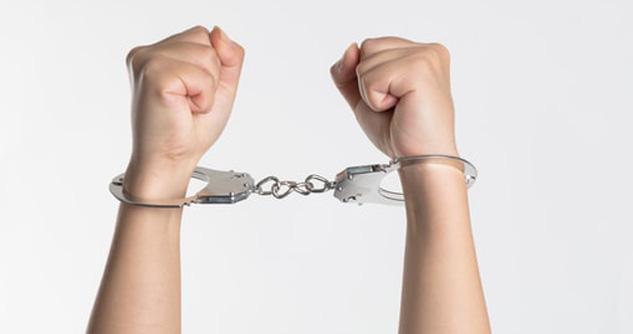Hands in handcuffs, white male, likely a teen