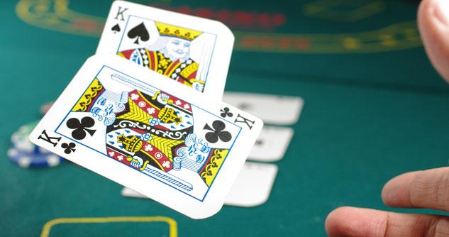 Gambler folds a pair of kings at the poker table