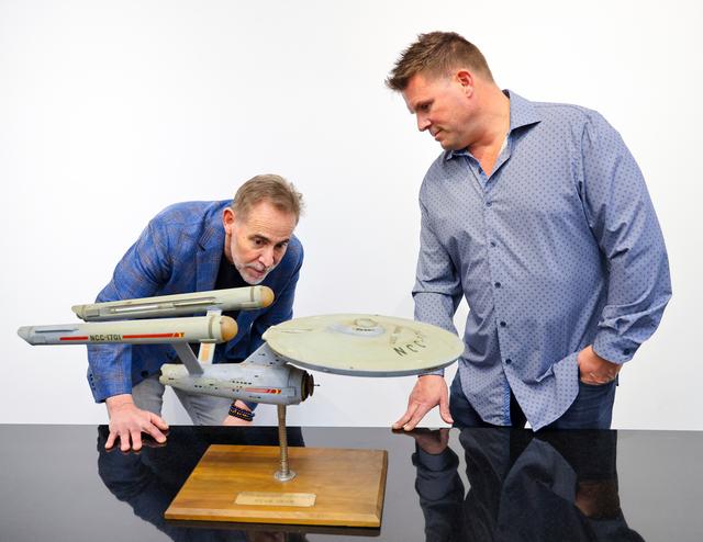 Joe Maddalena, executive vice president of Heritage Auctions, left, and Eugene “Rod” Roddenberry, the son of “Star Trek” creator Gene Roddenberry, view the recently recovered first model of the USS Enterprise at Heritage Auctions in Los Angeles