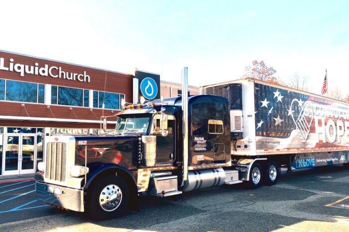 Big rig filled with food outside a church