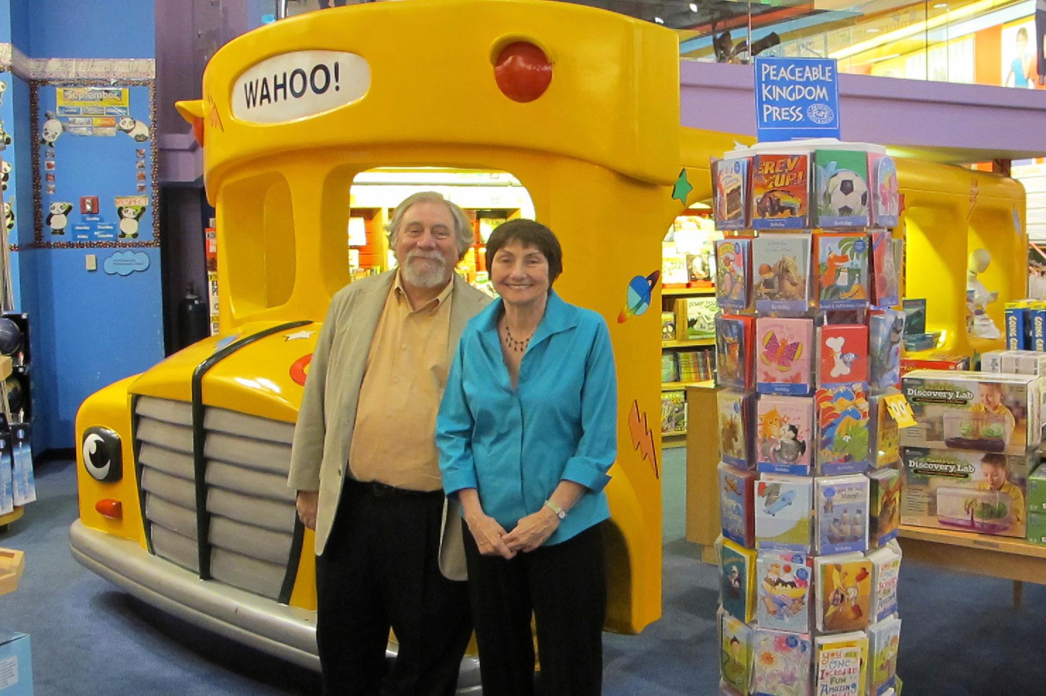 Joanna Cole and illustrator Bruce Degen in front of "Magic School Bus" display