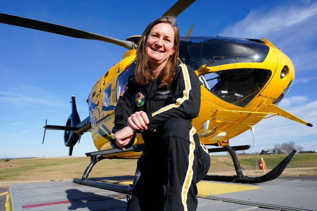 Air ambulance flight paramedic, Rita Krenz, poses in front of her company's helicopter