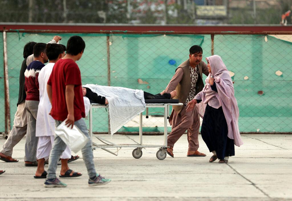 An injured school student is transported to a hospital after a bomb explosion near a school west of Kabul, Afghanistan