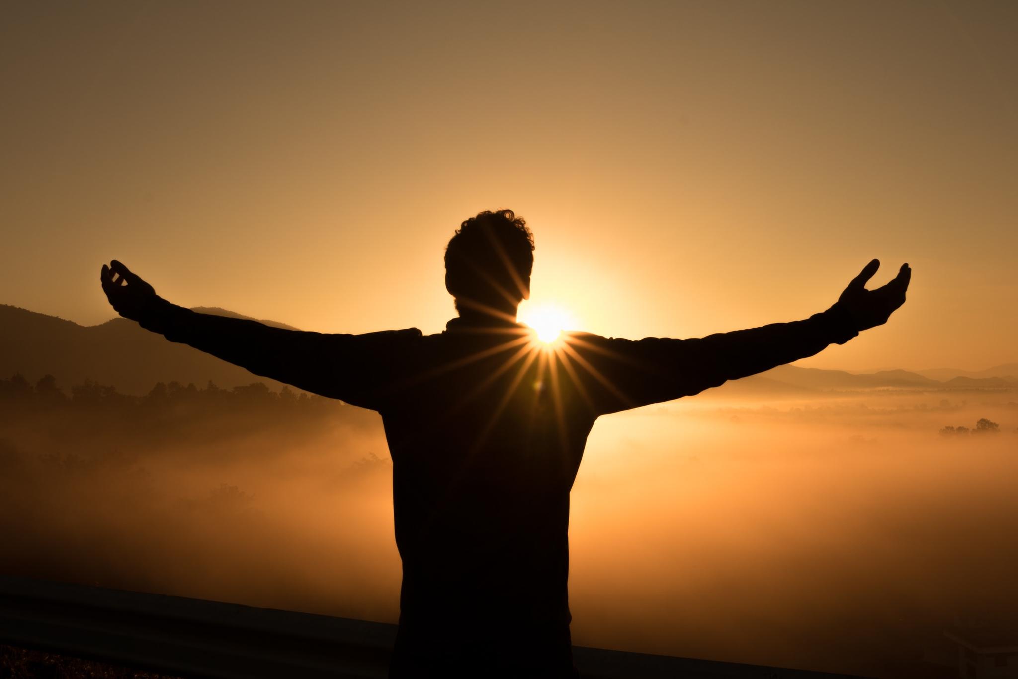 man worshipping with open arms