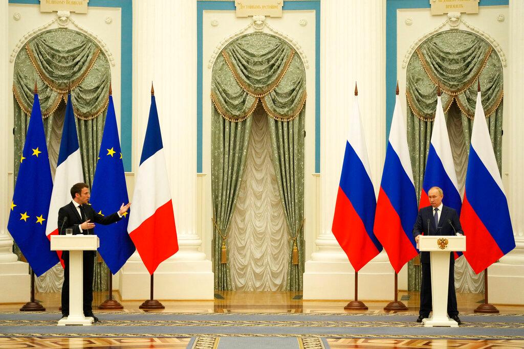 Russian President Vladimir Putin, right, listens during a joint press conference with French President Emmanuel Macron 