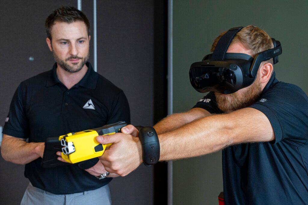 VR equipment and a version of the TASER 7 that utilizes VR technology for training, is demonstrated
