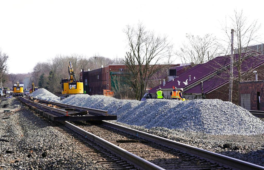 Equipment and gravel pile up along the railroad tracks